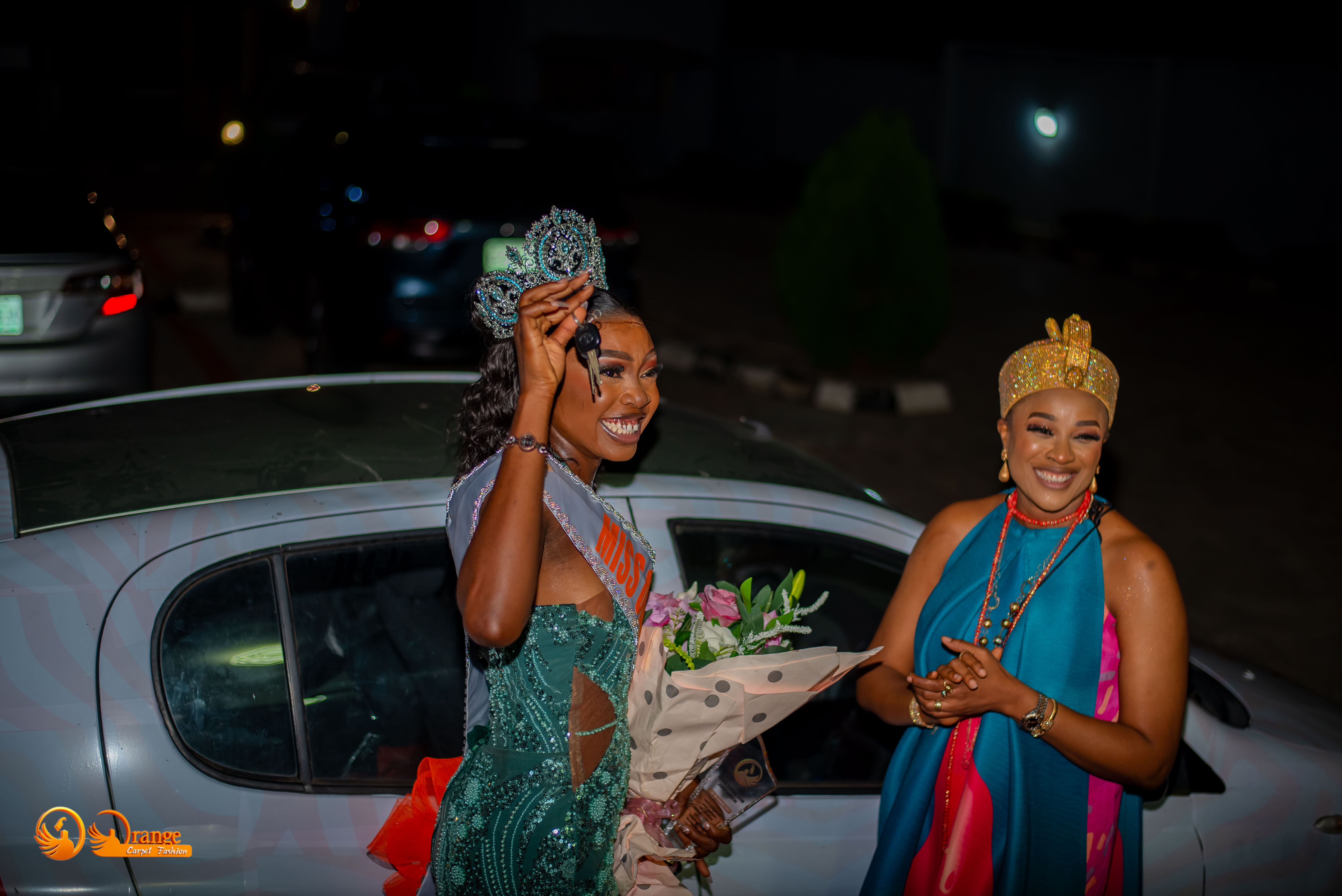 Abigael receiving car keys beside her new Toyota Yaris prize vehicle